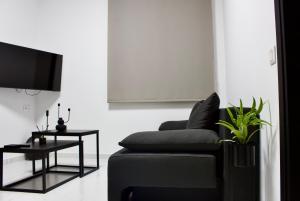 a living room with a couch and a tv at Easy Wave Premium Suites in Pylos