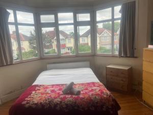 a bedroom with a bed and a large window at Hii in Harrow
