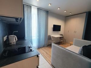 eine Küche und ein Wohnzimmer mit einem Sofa in der Unterkunft ЖК Аржанова in Dnipro