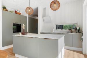 a kitchen with white cabinets and pendant lights at OH548-Hadsund-Sellegaarde-Vest-6-a in Hadsund