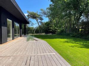a wooden walkway next to a yard with green grass at OH548-Hadsund-Sellegaarde-Vest-6-a in Hadsund