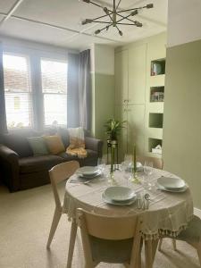 a living room with a table and a couch at Bridge House in Broadwater