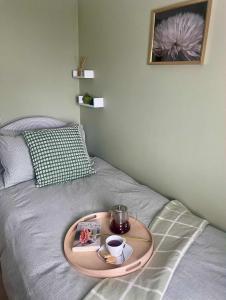 a tray on a bed with a tray of food on it at Bridge House in Broadwater