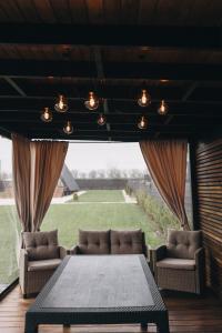 a living room with a table and chairs and a large window at Dravis Event Park 