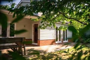 a house with a bench in front of it at Garden Villa in Cambridge