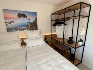 a bedroom with a bed and a book shelf at Mallorca Suites Playa De Palma in Palma de Mallorca