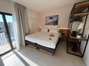 a hotel room with a bed and a balcony at Mallorca Suites Playa De Palma in Palma de Mallorca
