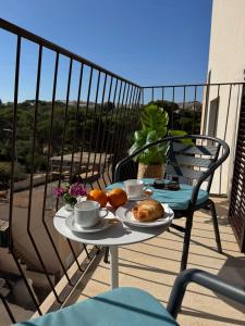 a table with a plate of food on a balcony at Mallorca Suites Playa De Palma in Palma de Mallorca