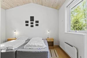 ein Schlafzimmer mit zwei Betten und einem Fenster in der Unterkunft 1583 Aakirkeby - Poserekrogen 8 in Vester Sømarken