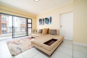 a living room with a couch and a large window at Ballito Hills 1153 in Ballito +36 photos
