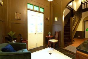 a living room with a door and a stair case at Casa Acero in Bangkok +4 photos