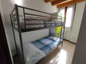 a couple of bunk beds in a room at Le Terrazze del Garda - Immobili e Soluzioni Rent in Manerba del Garda