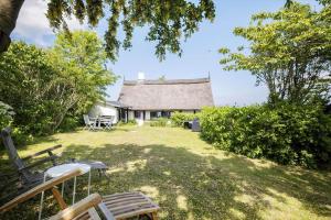 a view of a house with a thatch roof at 5580-Svaneke-Mor-Markers-Gaenge-13 in Svaneke