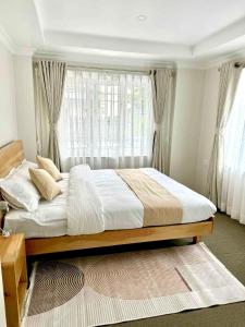 a bedroom with a large bed in front of a window at Peaceful 2BHK, Near Thamel & Swayambhu in Kathmandu