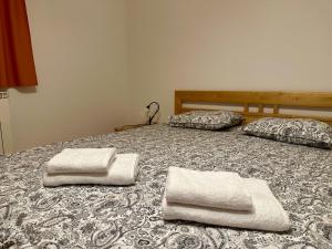 two towels sitting on top of a bed at Karol-ina Estate in Branik