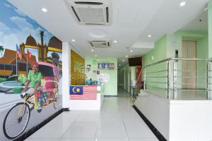 a hospital hallway with a bike painted on the wall at Dancenter G Home Hotel in Kota Bharu