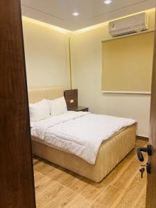 Postel nebo postele na pokoji v ubytování Gardinia City Apartment