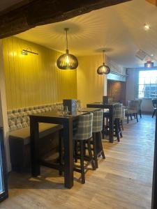 a dining room with tables and chairs and lights at The Boot Inn in Flyford Flavel +22 photos