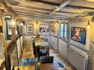 a dining room with a table and chairs in it at The Boot Inn in Flyford Flavel