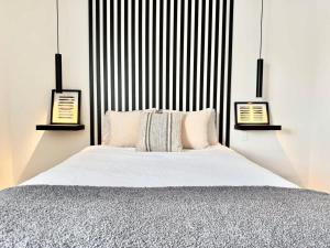 a bedroom with a large bed with black and white stripes at Levis Center New Studio #2 AC, WiFi and 2 Parking spaces in Lévis
