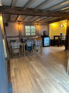 a dining room and kitchen with a table and chairs at The Boot Inn in Flyford Flavel +22 photos