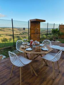 a wooden table and chairs on a wooden deck at B&B la collina Figurina in La Figurina
