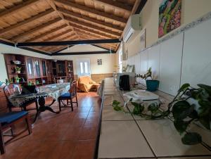 a large living room with a table and chairs at Janela da Aldeia in Lomba