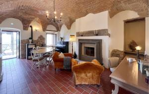 a living room with a couch and a fireplace at Lovely Apartment In Civitella Benazzone in Civitella Benazzone