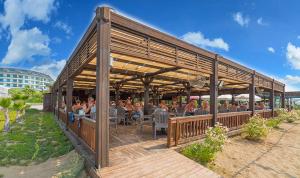 a group of people sitting inside of a restaurant at Side Breeze Hotel - Ultra All Inclusive in Side