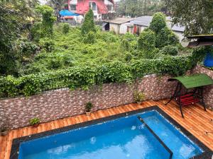 a small swimming pool on a wooden deck at Enclave Villa 4BHK in Lonavala