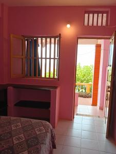 a room with a bed and a window and a door at Om Ganesh Naik Guest House in Arambol