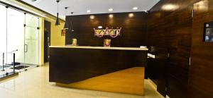 a lobby with a counter with a cross on it at Ranis Grand in Coimbatore