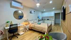 a bedroom with a bed and a desk and a kitchen at Perfect for groups 5BR retreat in Harristown