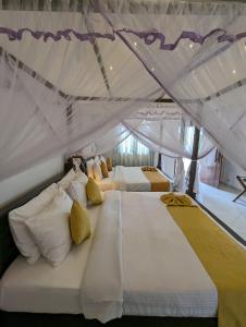 a bedroom with two beds in a tent at Eco Hotel Black & White - Anuradhapura in Mihintale