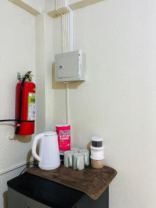 a counter with a coffee maker and cups on it at Casa Huway in El Nido
