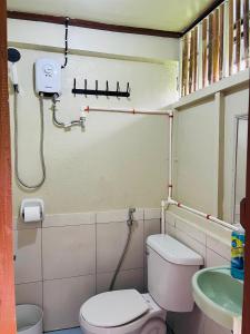a bathroom with a toilet and a sink at Casa Huway in El Nido +12 photos