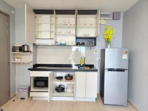 a kitchen with white cabinets and a refrigerator at The base Central Pattaya 2 bedrooms in Pattaya Central