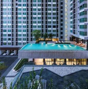 a swimming pool in a building with tall buildings at The base Central Pattaya 2 bedrooms in Pattaya Central