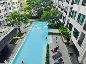 an overhead view of a swimming pool between two buildings at The base Central Pattaya 2 bedrooms in Pattaya Central