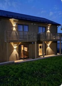 a house with a large deck on the side of it at Thunehuset in Andøya
