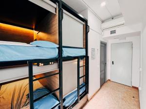 a room with bunk beds and a hallway at MadVibes Hostel Gran Vía in Madrid +33 photos