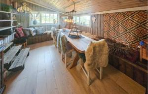 a living room with a table and a couch at 3 Bedroom Lovely Home In Dagali in Dagali