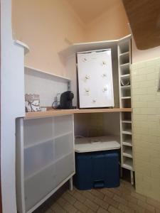 a small kitchen with a sink and a shelf at house Cicognola offers comfort and convenience between Lake Maggiore, Malpensa Airport, Novara, Varese and Milan in Castelletto sopra Ticino