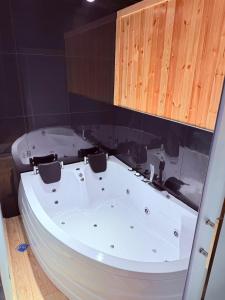a large white bath tub in a bathroom with a wall at Hotel Badamdar Baku in Baku +75 photos