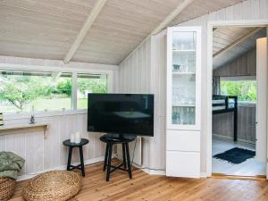 ein Wohnzimmer mit einem Flachbild-TV in einem Haus in der Unterkunft Secluded Haven in Hvidbjerg - By Traum Ferienwohnungen in Egeskov