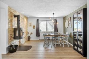 a kitchen and dining room with a table and chairs at OH512-Hadsund-Fiskerihavnsvej-7 in Hadsund