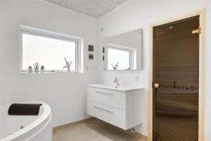 a white bathroom with a tub and a sink and a toilet at OH306-Hadsund-Ridestien-3 in Hadsund +16 photos