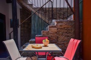 a table and chairs with a bowl of food on it at Doña Vicenta Casa Colonial in Guanajuato