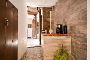 a kitchen with wooden walls and a counter with a coffee maker at Doña Vicenta Casa Colonial in Guanajuato