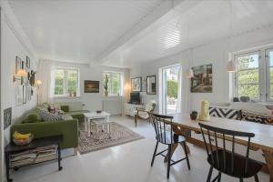 a living room with a green couch and a table at 5522-Svaneke-Bakken-5 in Svaneke